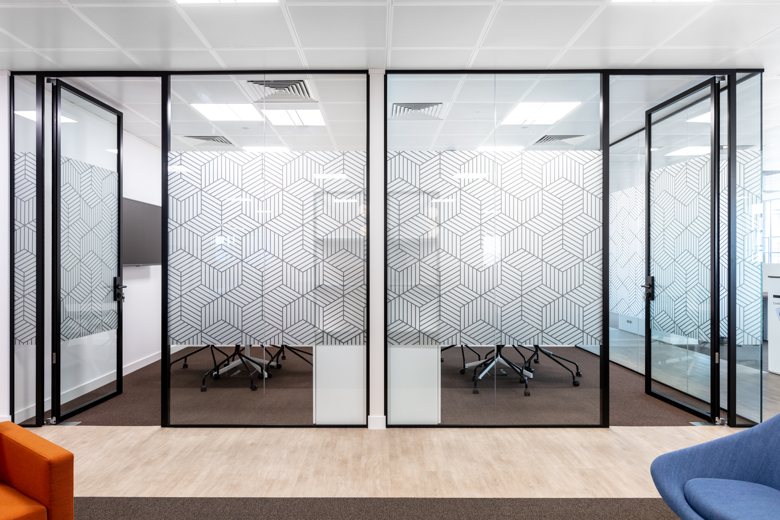 A spacious conference room at Ring Central featuring a long marble table, leather chairs, and large windows that flood the room with natural light, enhancing the professional ambiance.