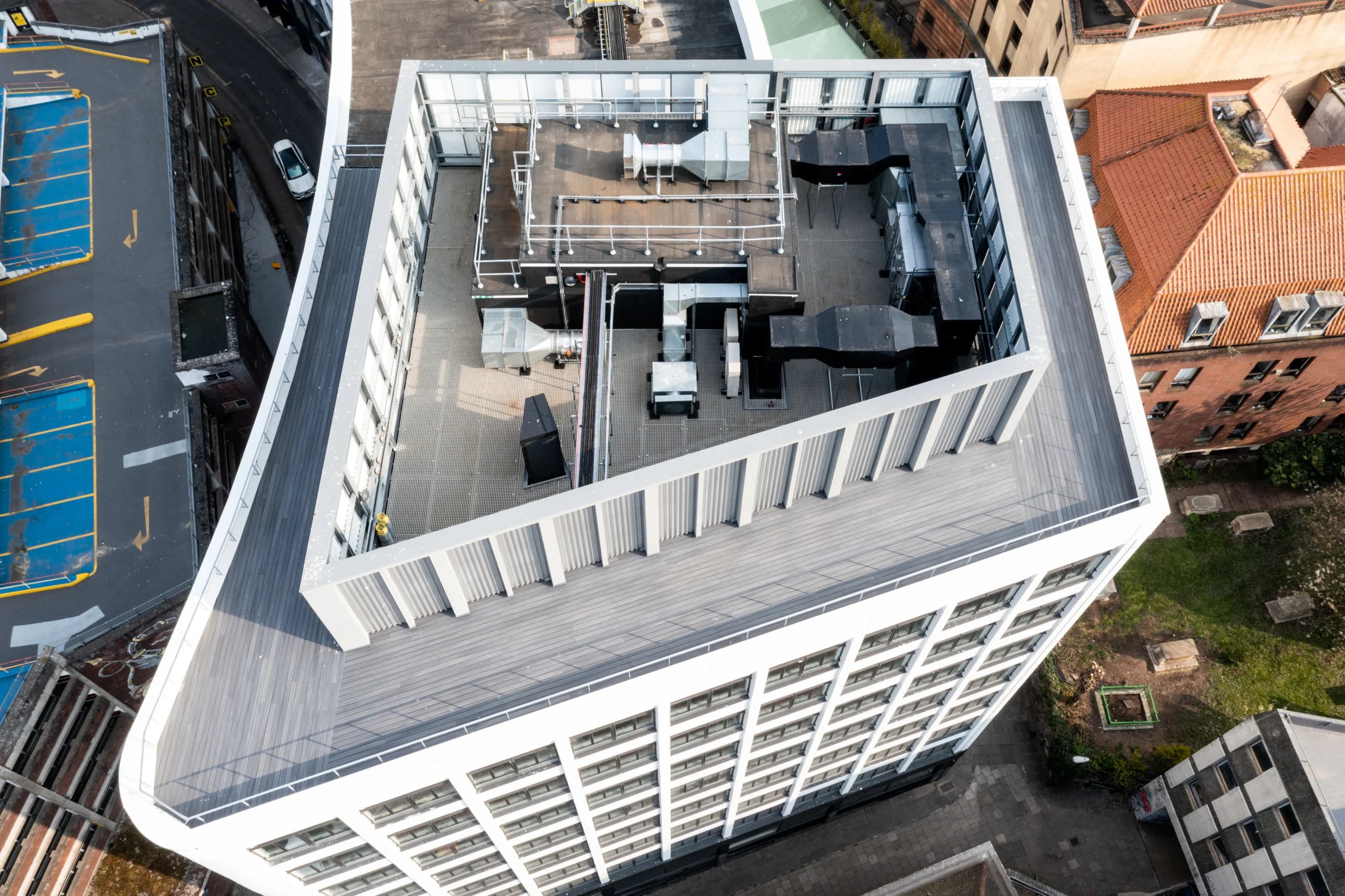 Aerial view of the rooftop at the Programme Building, showcasing the structured layout of ventilation systems and equipment against a modern architectural frame.