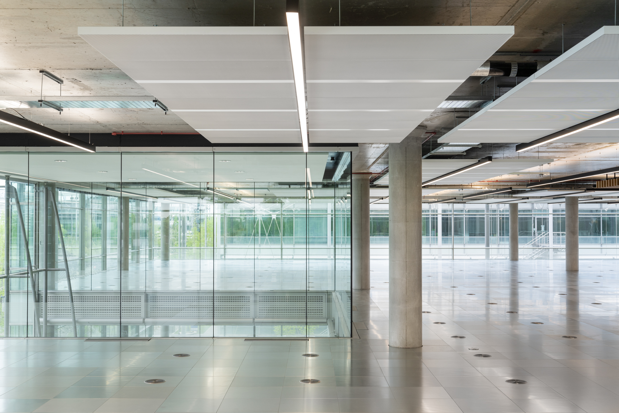 Glass-walled meeting area and exposed ceiling at Chiswick Business Park Building 12 - designed by Ambit for flexibility