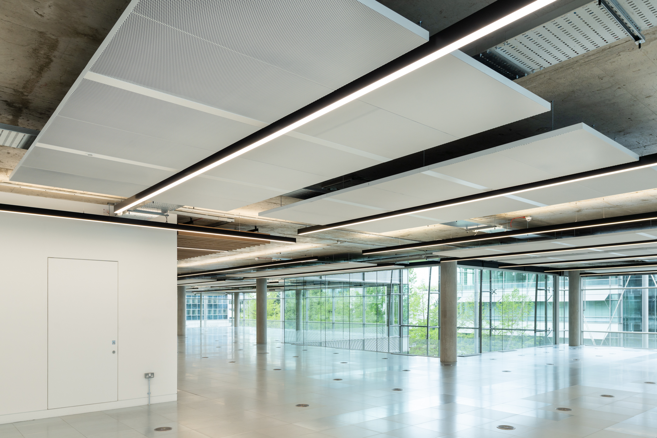 Contemporary ceiling design with exposed beams and lighting at Chiswick Business Park Building 12 - flexible Cat-A space by Ambit