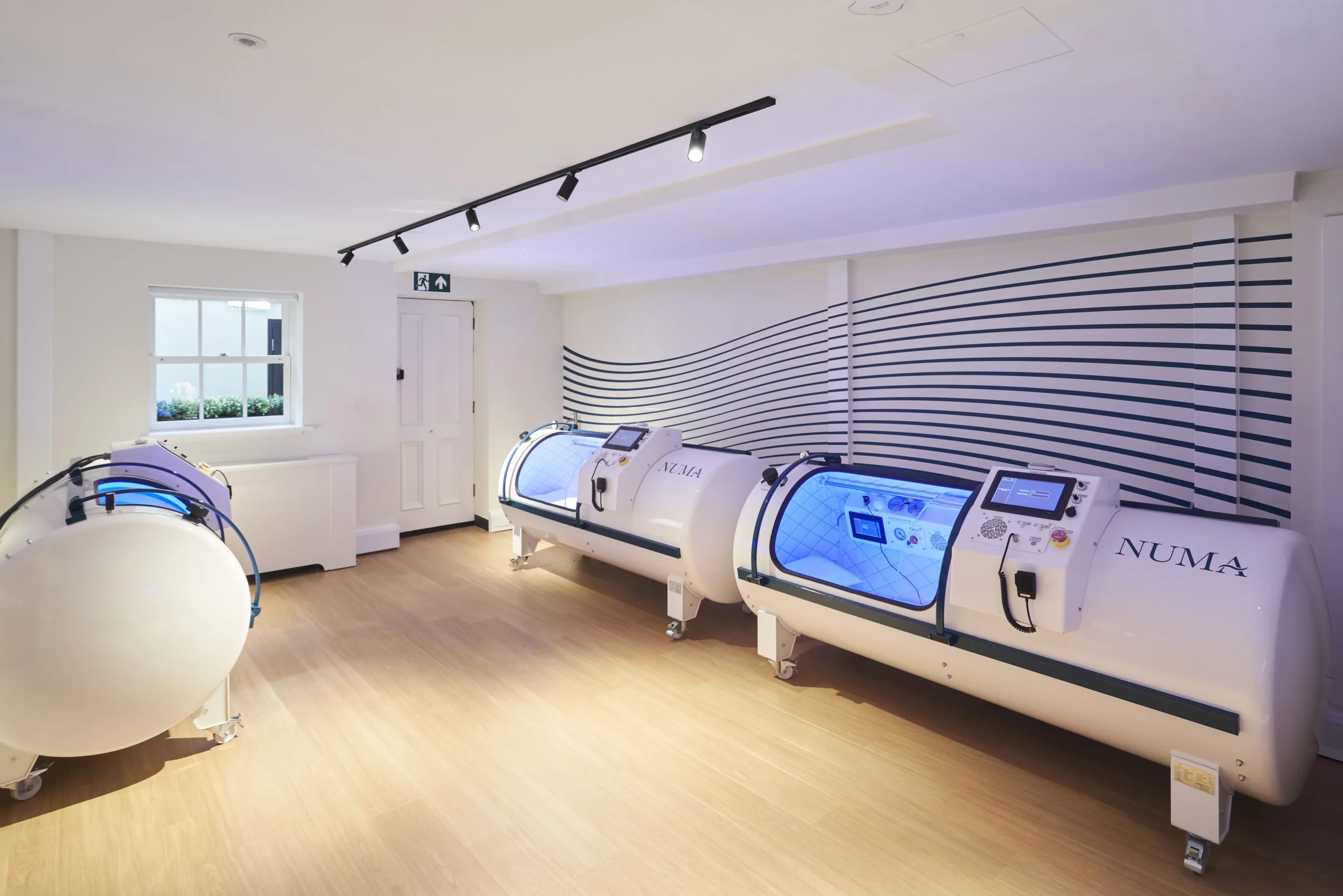 Oxygen therapy capsules in therapy room at Numa - Ambit fit-out with modern equipment and design