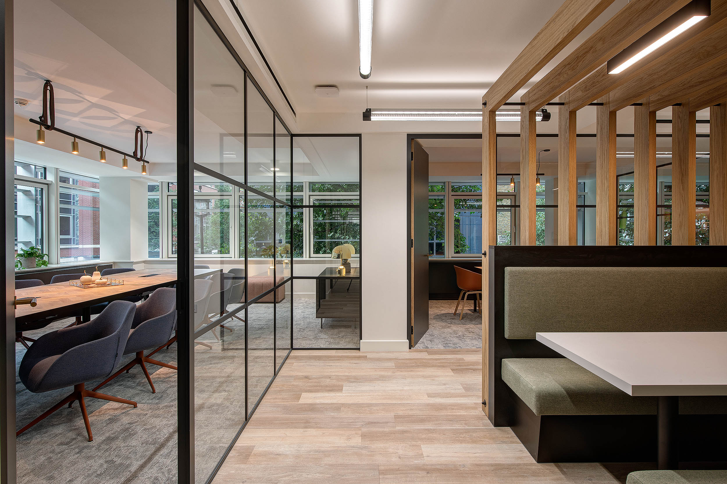 Sophisticated oak hallway with meeting rooms and an open collaborative seating area