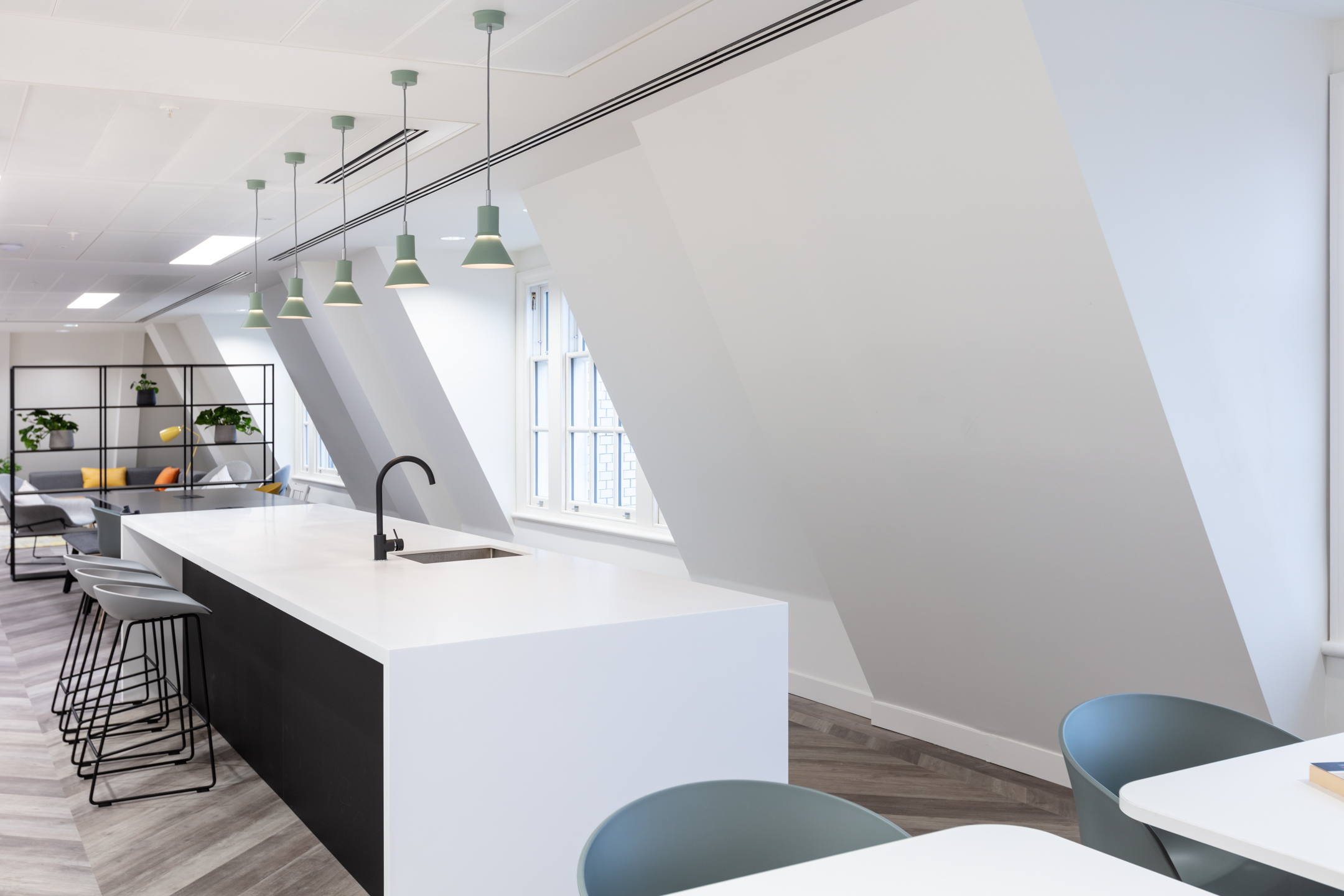 20 St James’s Street, Level 8 teapoint area with a sleek white island, pendant lighting, and contemporary seating, providing a relaxed environment for informal meetings