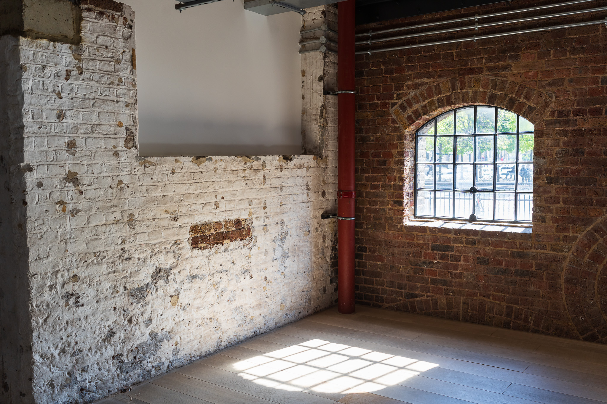 Brick walls with large open window filling the room with natural light