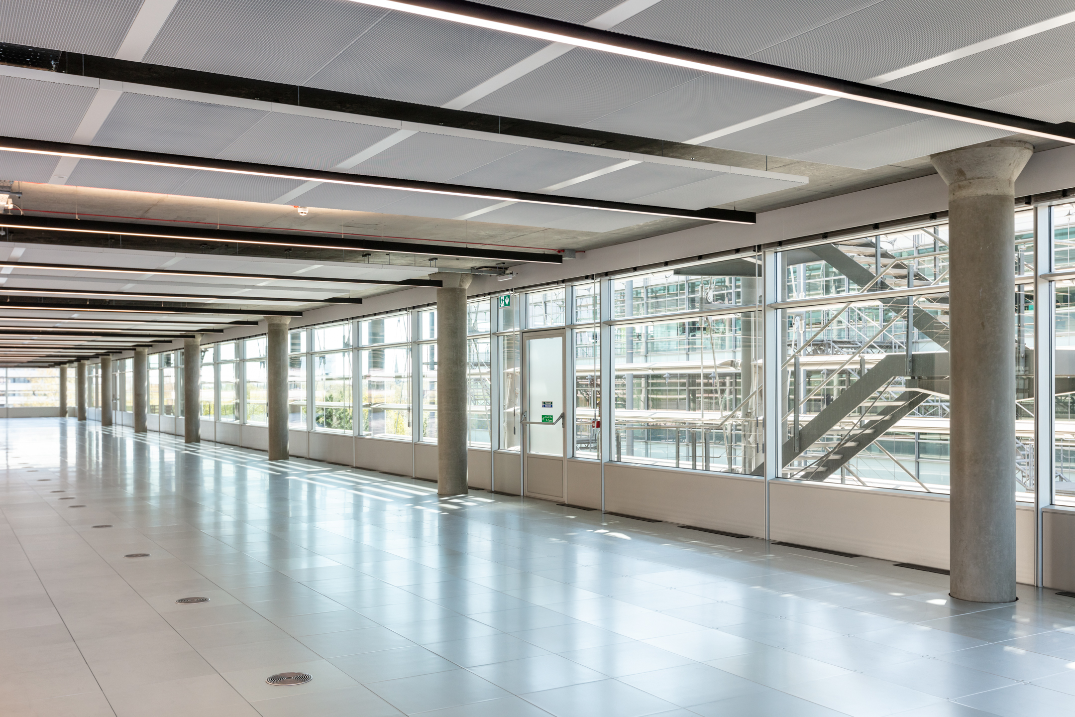 A bright and open CAT A workspace with floor-to-ceiling windows, flooding the area with natural light.